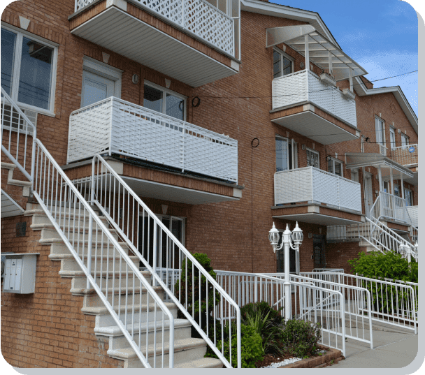 A row of brick buildings with white stairs.