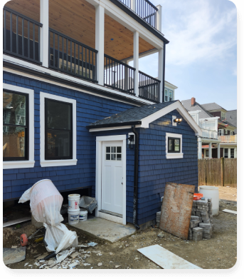 A house that is being remodeled with blue siding.