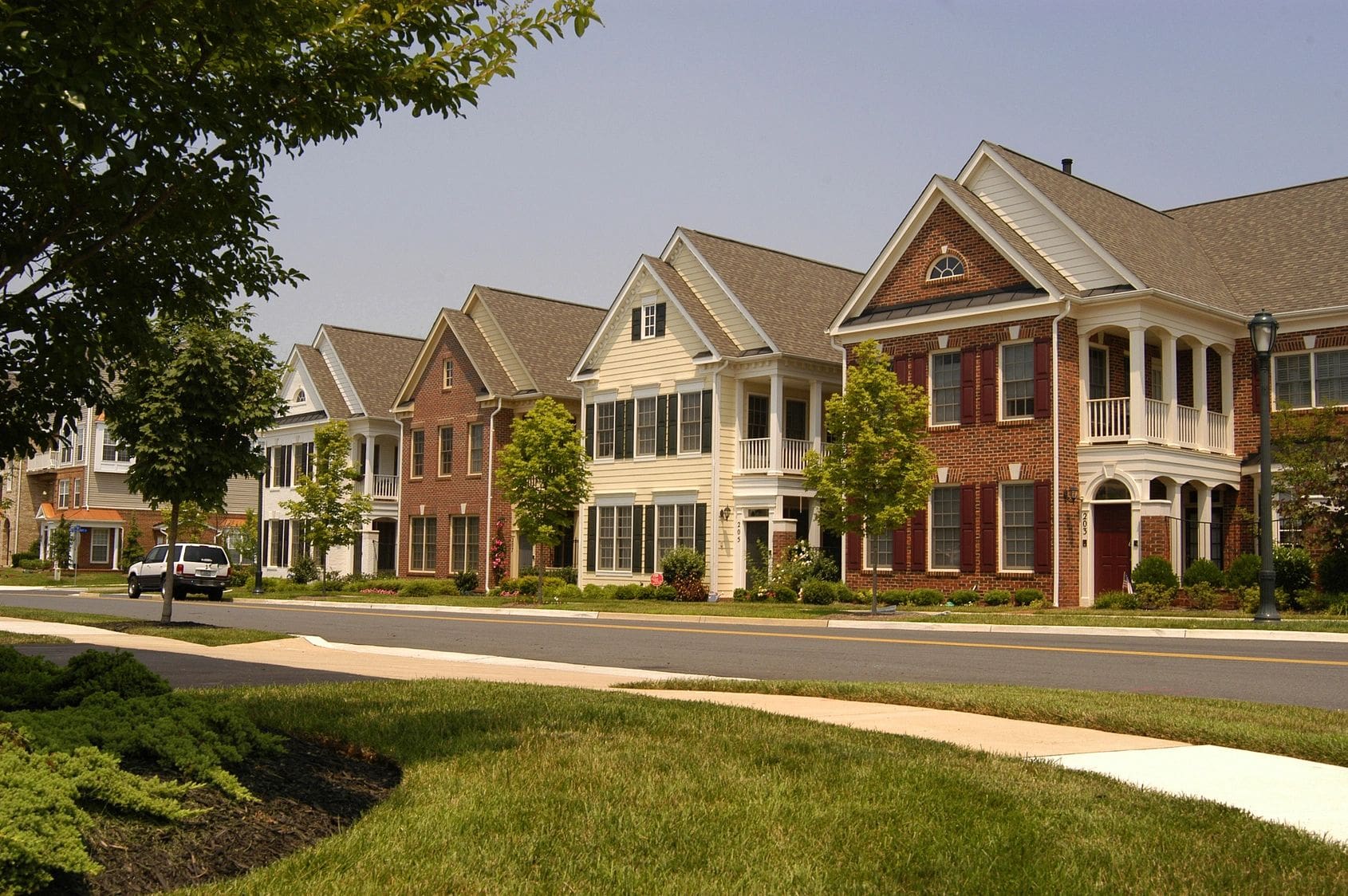 A row of houses on the side of a street.