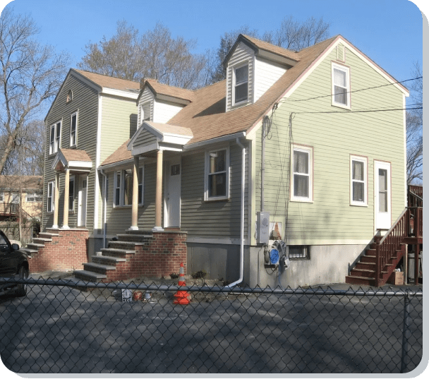 A house with two levels and three windows.